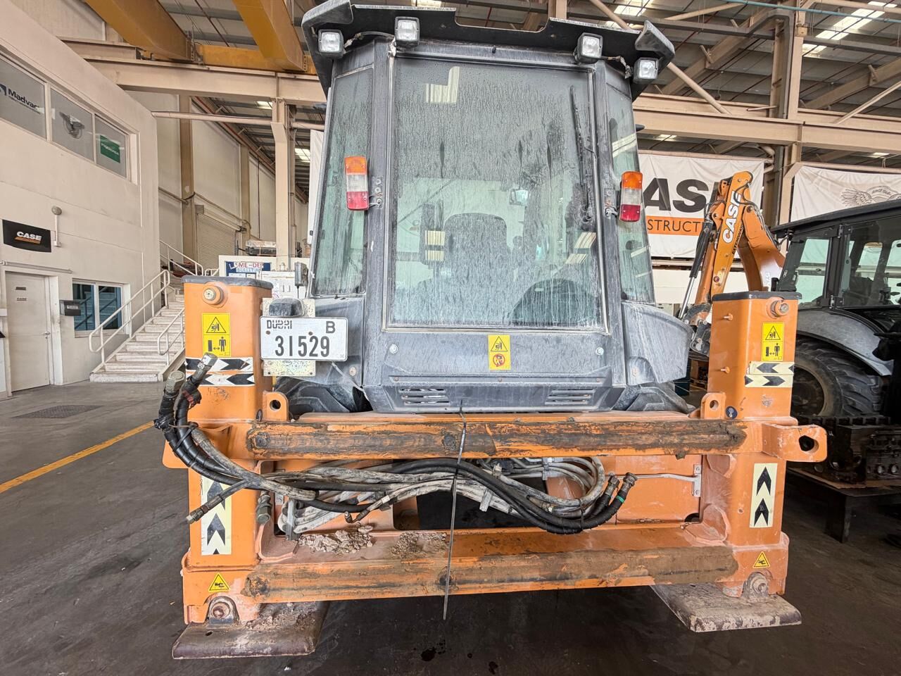 Backhoe loader in workshop