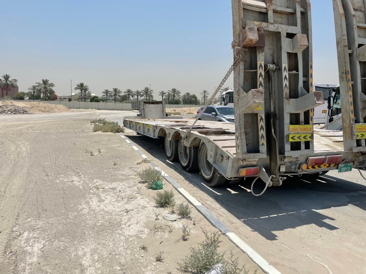 Low-bed trailer on a desert road in Dubai during an LSLA inspection