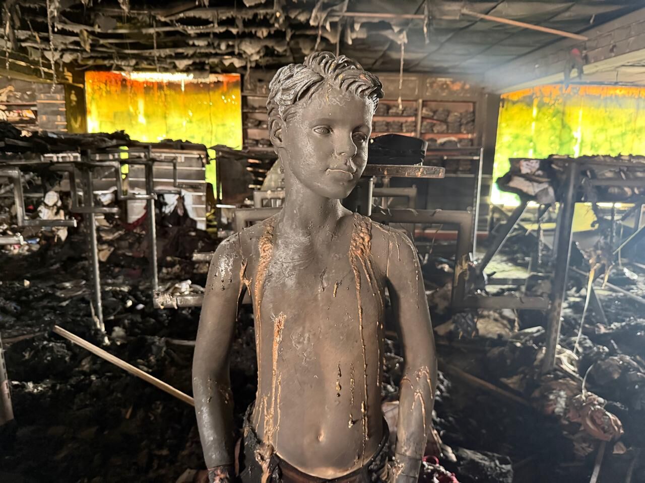 Soot-covered mannequin in burnt shop